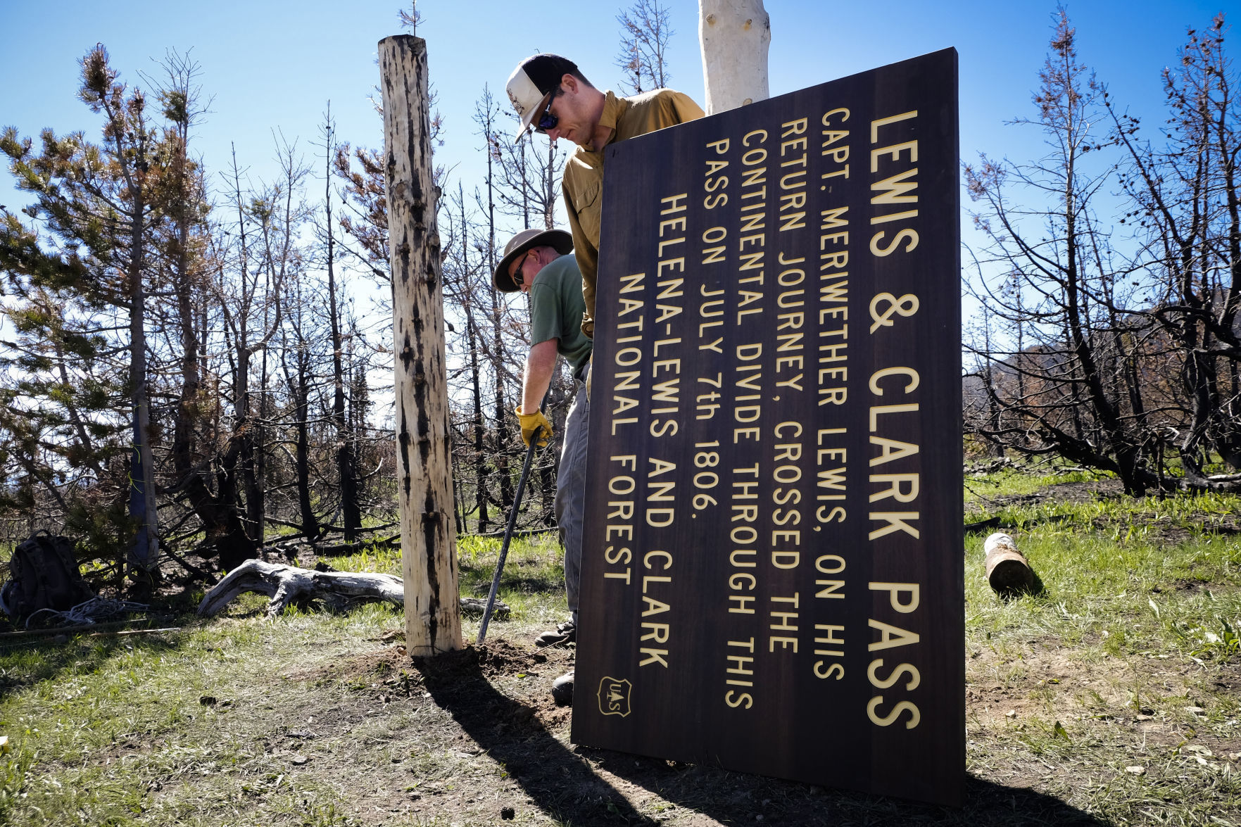 Sonny Mazzullo, stewardship coordinator with the Montana Wilderness Association, center, works with a volunteer